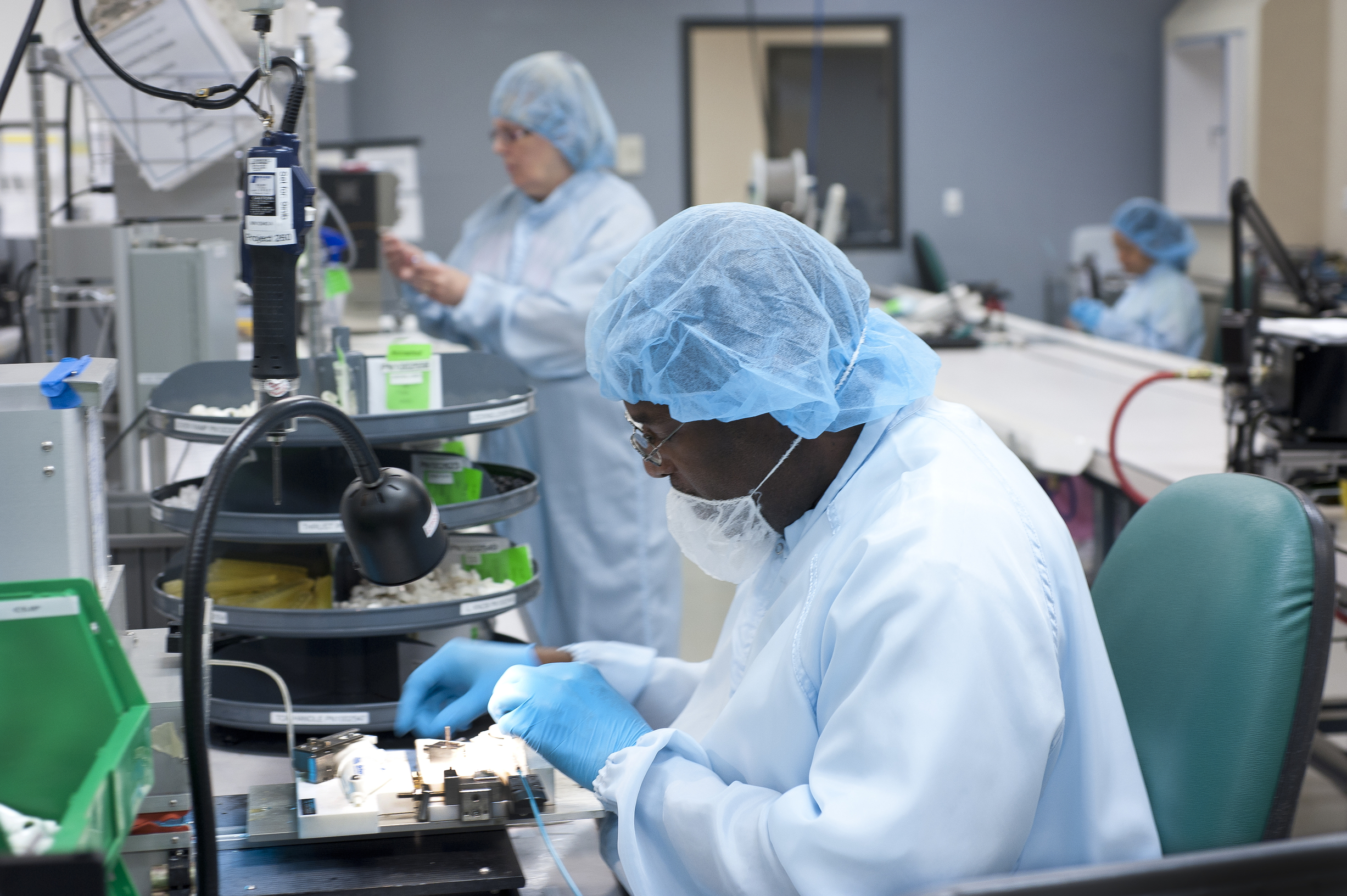 Technicians wearing PPE in a lab.