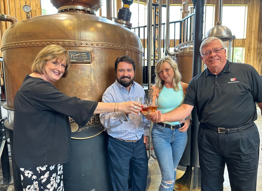 Four people drinking bourbon at a Shelby County distillery